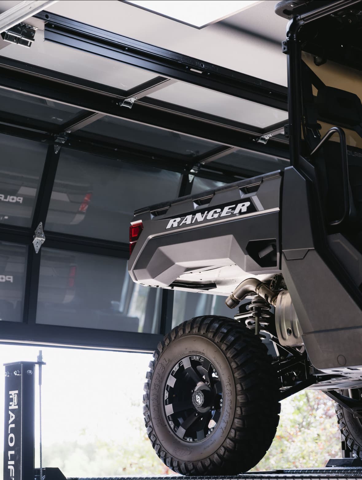 Halo 4-post car lift with Polaris Ranger installed by My Ultimate Garage